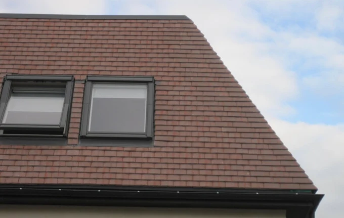Close up of clean red tiled slope with Velux windows